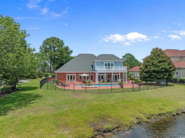 Back of property with a balcony, a patio, and brick siding | Image 19