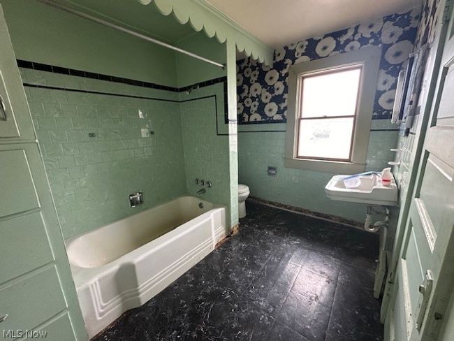 Full bathroom with tile floors, sink, toilet, and tiled shower / bath combo | Image 14