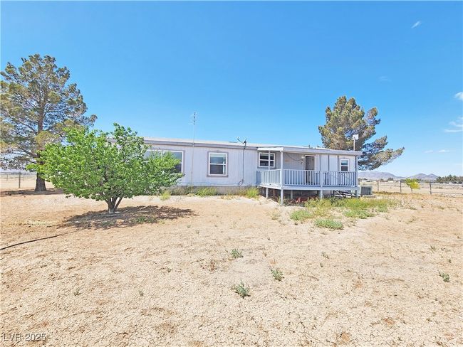 View of front of property with a deck and fence | Image 32
