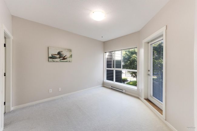 Spare room with light carpet and baseboard heating | Image 14