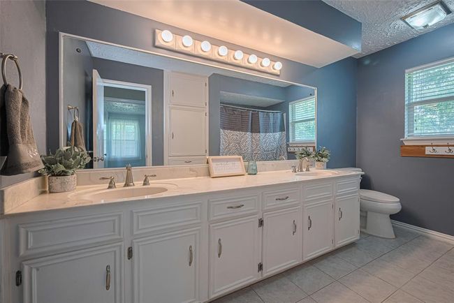 Second bathroom upstairs features dual sinks and recently updated shower & tub. | Image 25