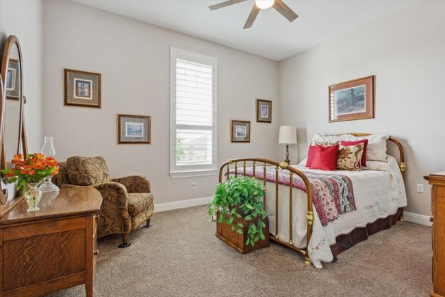 Guest Bedroom with walk in closet, carpet flooring and ceiling fan | Image 24