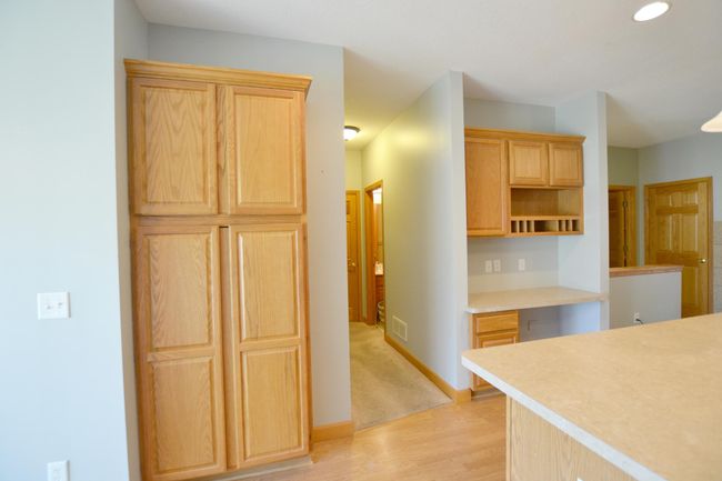 Pantry with Ample Storage & Built-In Desk Stay organized with a spacious pantry & a convenient built-in desk—perfect for work or home management. | Image 9