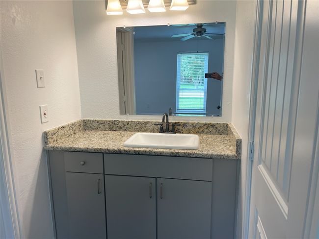 Bathroom featuring vanity, a textured wall, and a ceiling fan | Image 6