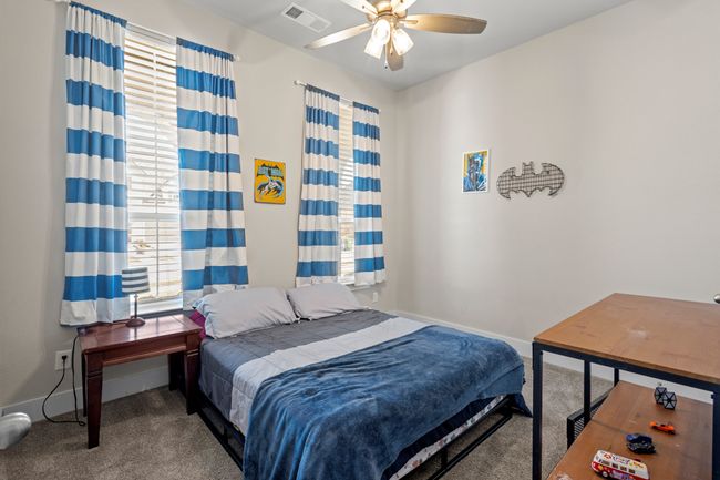 Bedroom with baseboards, visible vents, carpet floors, and ceiling fan | Image 28