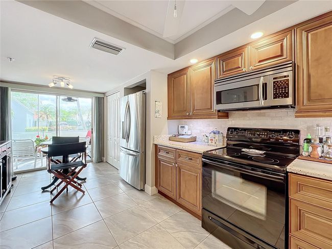 Eat-in kitchen has additional storage and large pantry | Image 22