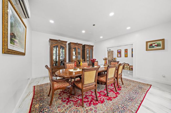 Formal dining room with ample space and elegant surrounding | Image 15