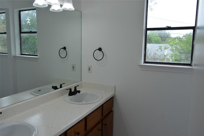 Bathroom with double vanity and a chandelier | Image 8