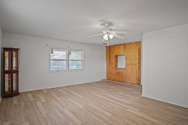 Spare room featuring light wood finished floors and ceiling fan | Image 16