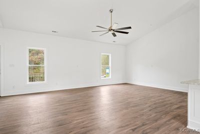 Family room featuring lofted ceiling, ceiling fan, hardwood / wood-style floors, and plenty of natural light | Image 2