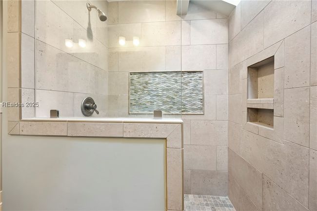 Large tile and stone shower with skylight in 2nd Primary Suite | Image 33