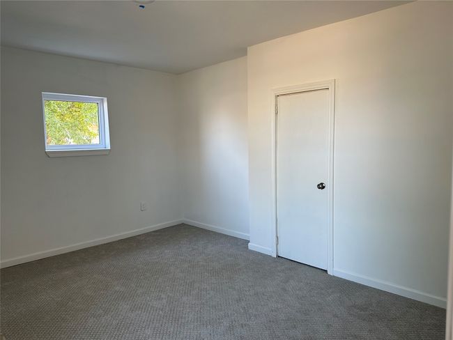 Unfurnished room with dark carpet and baseboards | Image 16