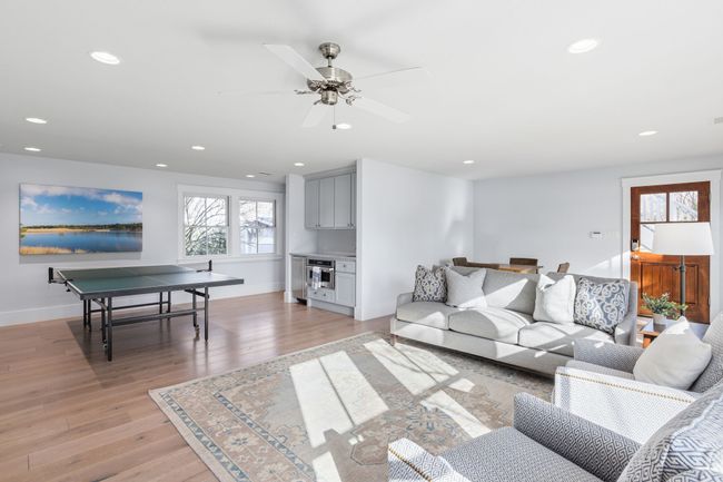 Living room with recessed lighting, baseboards, ceiling fan, and light wood-type flooring | Image 33