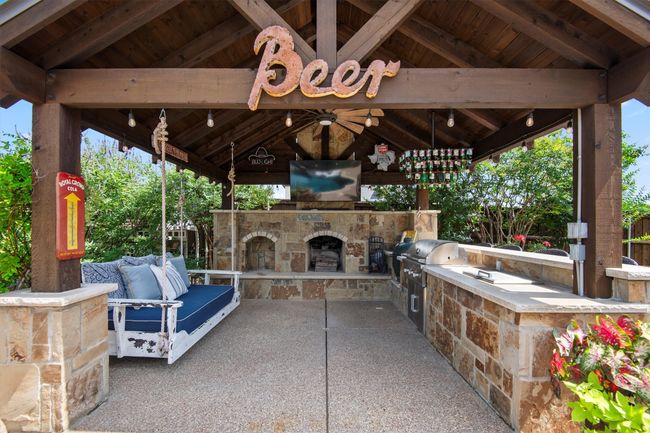 View of patio with a gazebo, area for grilling, and an outdoor stone fireplace | Image 29