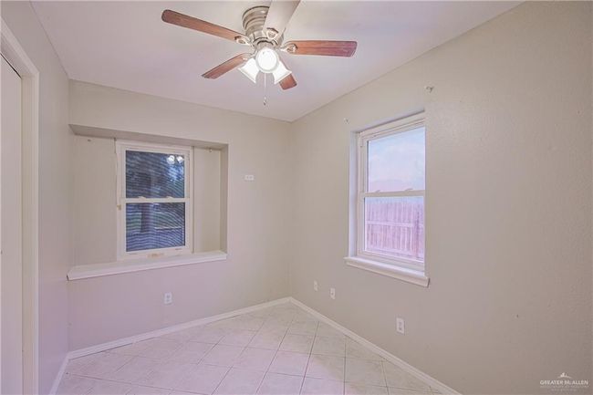 Spare room with light tile patterned floors, a ceiling fan, and baseboards | Image 22