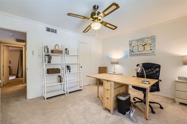 Home office featuring light colored carpet, ceiling fan, ornamental molding, and baseboards | Image 19