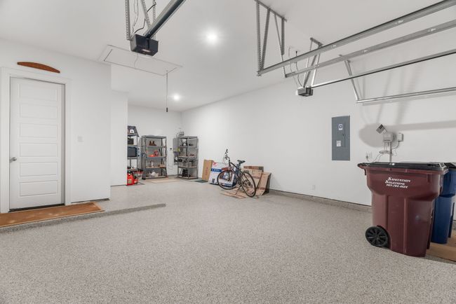 Garage with electric panel and a garage door opener | Image 34