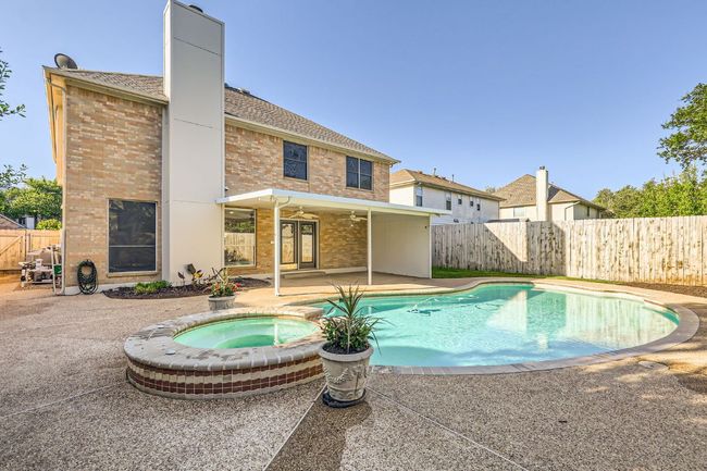 View of pool with a patio, a fenced backyard, a ceiling fan, and an in ground hot tub | Image 6