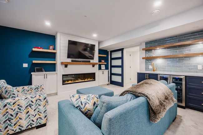 Living room featuring light colored carpet, wet bar, and recessed lighting | Image 28