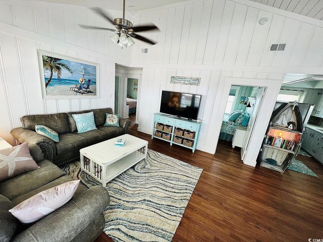 Living room featuring ceiling fan and dark hardwood / wood-style floors | Image 10