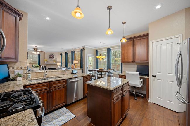 Kitchen with island and a built in work center | Image 17