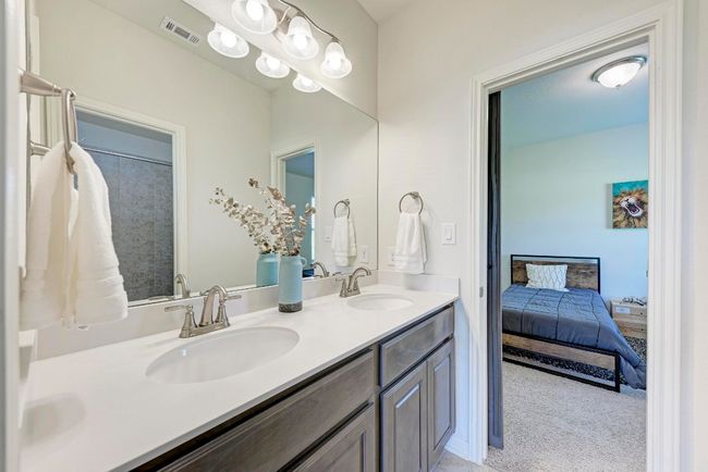 Secondary bedrooms #2 and #3 share this privacy divided Hollywood-style bath, with double vanity and tub/shower combination. | Image 32