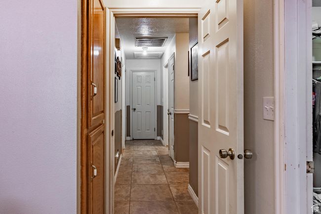 Corridor featuring baseboards and tile patterned floors | Image 37