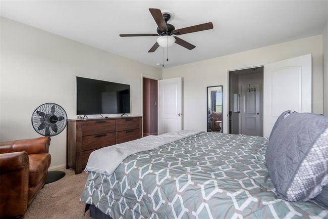 Primary bedroom with ceiling fan and natural light | Image 15