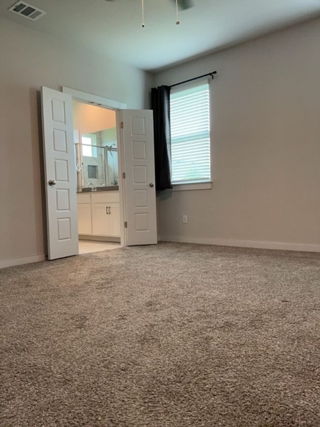 Primary bedroom featuring carpet flooring and ensuite bathroom | Image 15