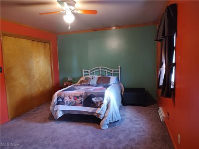 Bedroom with ceiling fan, carpet flooring, and a closet | Image 3