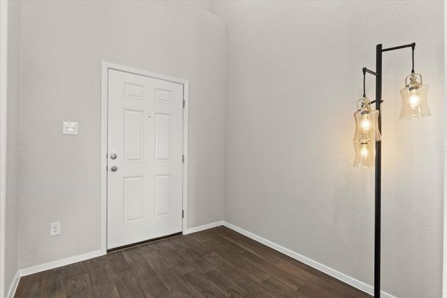 Spare room with dark wood-style flooring and baseboards | Image 7