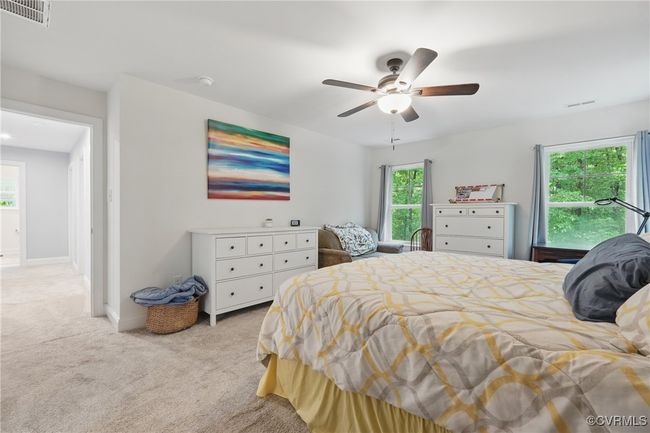 Primary suite with walk-in closet and direct access to ensuite bath. | Image 17
