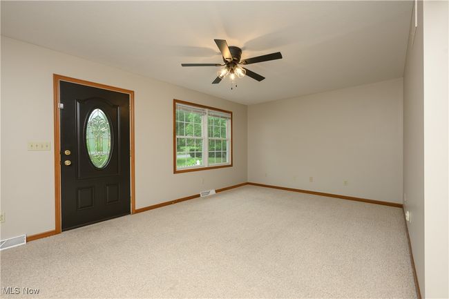 Carpeted entryway with baseboards and ceiling fan | Image 6