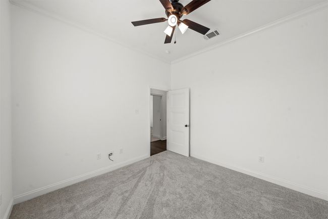 Spare room featuring carpet flooring, ornamental molding, and ceiling fan | Image 14