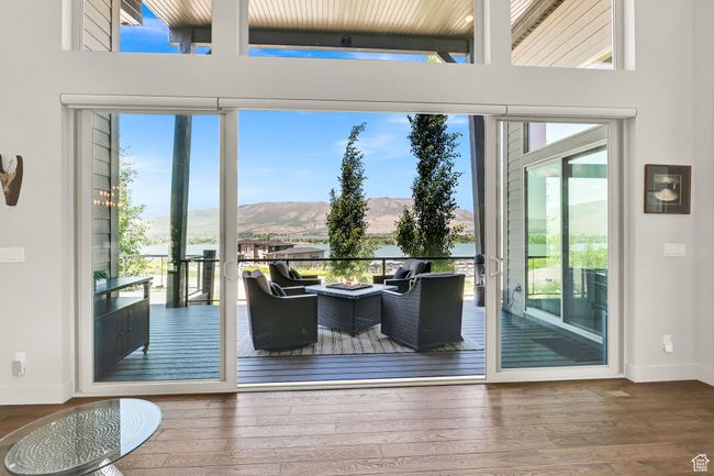 Doorway to outside featuring plenty of natural light, a mountain and lake view, baseboards, and wood-type flooring | Image 19