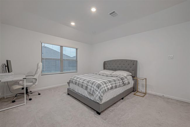 Retreat to the generously sized primary suite, complete with an ensuite featuring a walk-in shower, elegant vanity, and a spacious walk-in closet. | Image 31