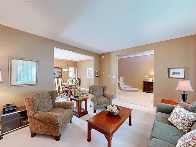 Living area with stairs and light carpet | Image 12