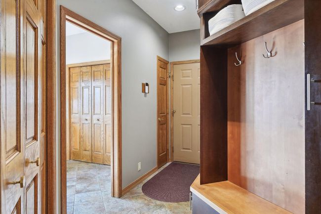Built in locker with lower storage featuring a floor drain for those snowy, wet boots/shoes | Image 27