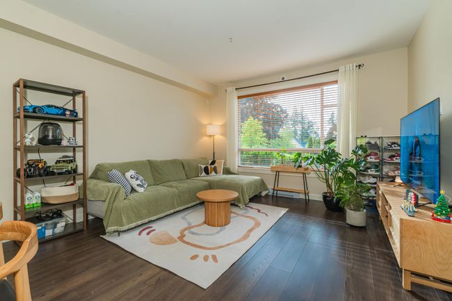 Living room with wood finished floors and baseboards | Image 8