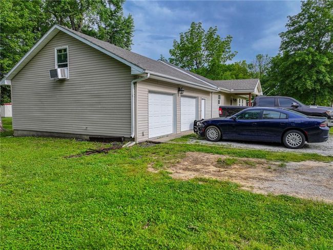 View of home's exterior featuring driveway, a garage, and a yard | Image 9