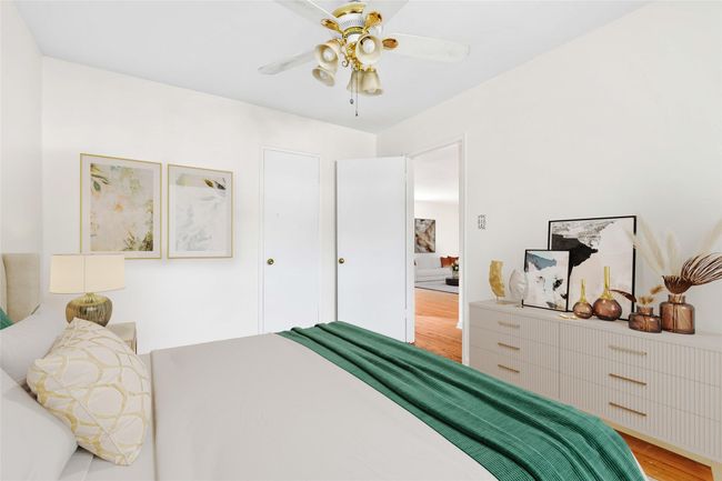 Bedroom with light wood finished floors and a ceiling fan | Image 7