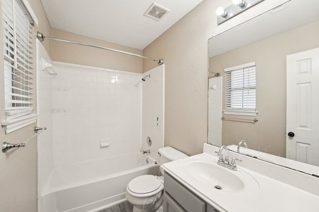 Bathroom featuring washtub / shower combination and vanity | Image 15