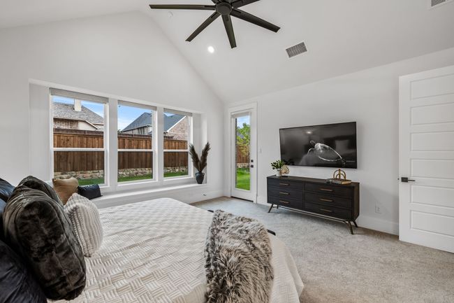 Bedroom with light colored carpet, access to exterior, high vaulted ceiling, and ceiling fan | Image 20