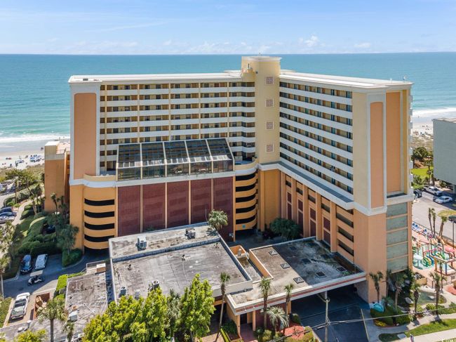 View of building exterior featuring view of water and beach | Image 22