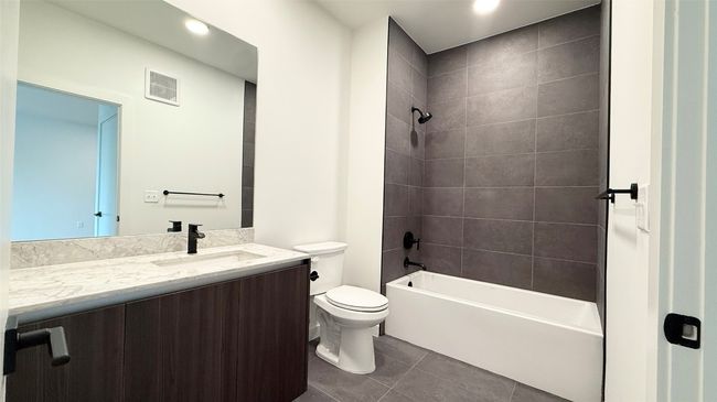 Bathroom featuring vanity, tile patterned floors, tub / shower combination, and recessed lighting | Image 16