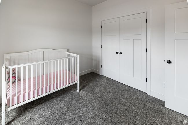 Bedroom featuring baseboards, a crib, carpet floors, and a closet | Image 22