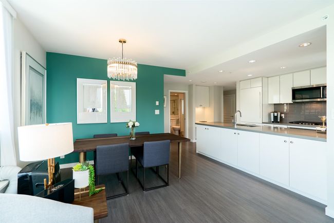 Dining space featuring dark wood finished floors, a chandelier, and recessed lighting | Image 5