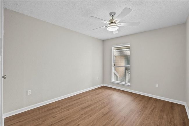 A roomy 2nd bedroom with natural light pouring in—ideal for guests or turning into your next cozy spot | Image 23
