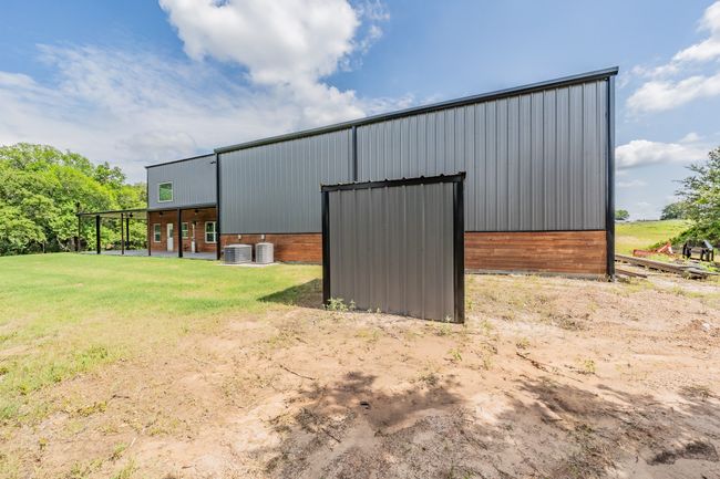 View of pole building with central air condition unit and a yard | Image 10