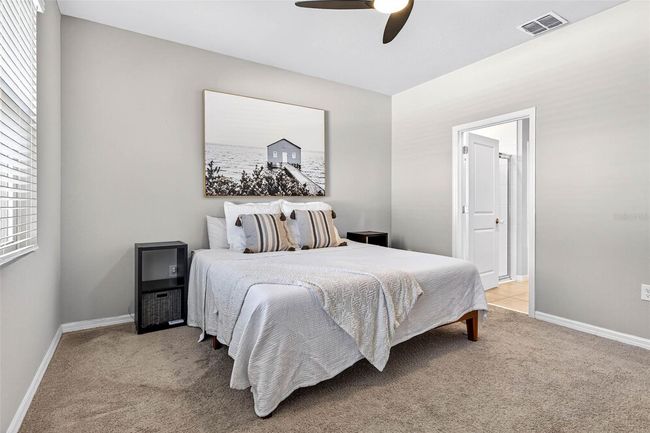 Primary suite on first floor has ensuite bath and walk in closet. | Image 17